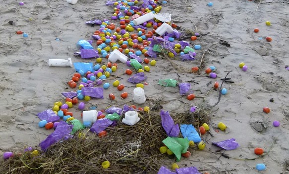 epa05699078 A handout photo made available by Langeoog Police Station on 04 January 2017 shows plastic eggs containing tiny toys (Ueberraschungseie) that were swept ashore at a beach of North Sea isla ...