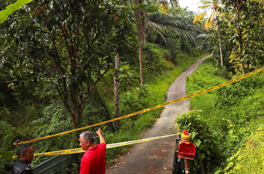 epa07770769 Police cordon an area as the search and rescue operation for 15-year-old Nora Quoirin from London is continued, in Seremban, Negeri Sembilan, Malaysia, 13 August 2019. Nora disappeared whi ...