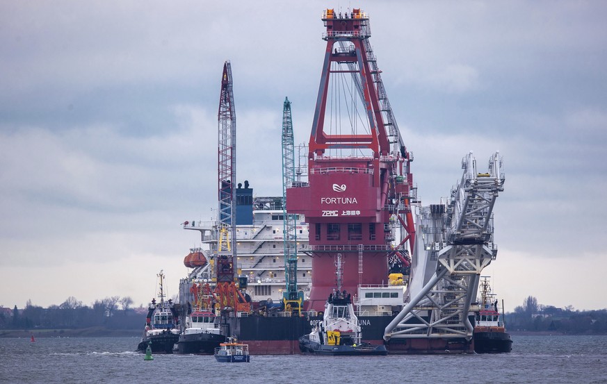 Tugboats get into position on the Russian pipe-laying vessel &quot;Fortuna&quot; in the port of Wismar, Germany, Thursday, Jan 14, 2021. The special vessel is being used for construction work on the G ...