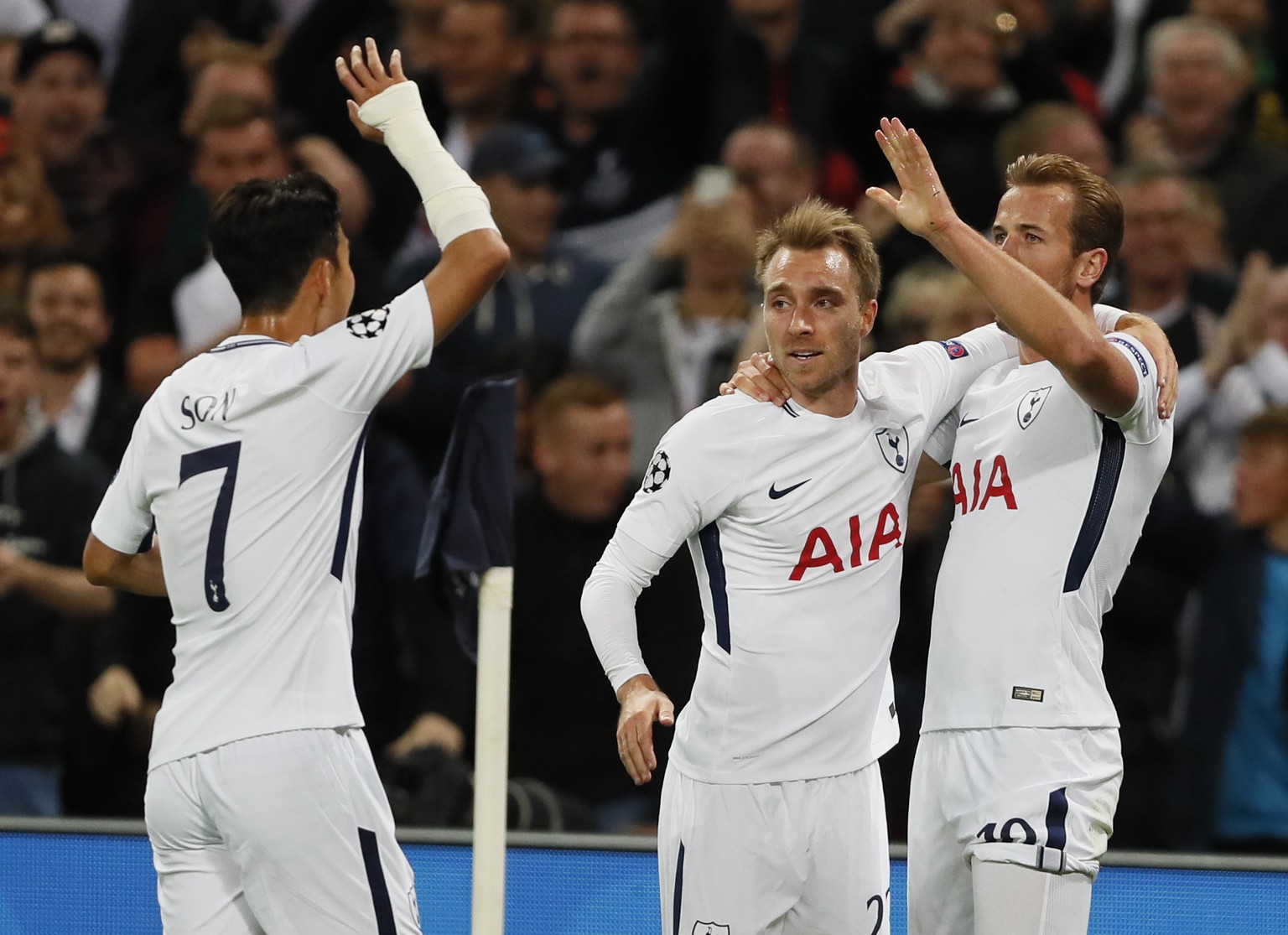 Tottenham&#039;s Harry Kane, right, celebrates with his teammate Christian Eriksen, center and Son Heung-min after scoring during the Champions League group H soccer match between Tottenham and Boruss ...