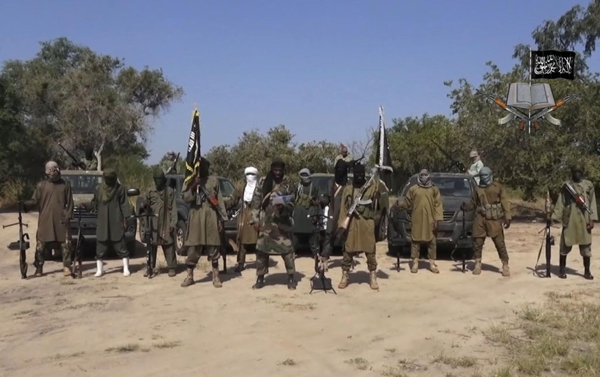 FILE - In this file image taken from video released Friday Oct. 31, 2014, by Boko Haram, Abubakar Shekau, centre, the leader of Nigeria&#039;s Islamic extremist group, surrounded by his fighters. Nige ...