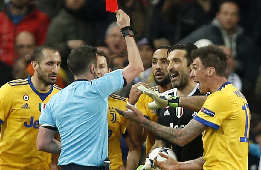Referee Michael Oliver shows a red car to Juventus goalkeeper Gianluigi Buffon during a Champions League quarter final second leg soccer match between Real Madrid and Juventus at the Santiago Bernabeu ...