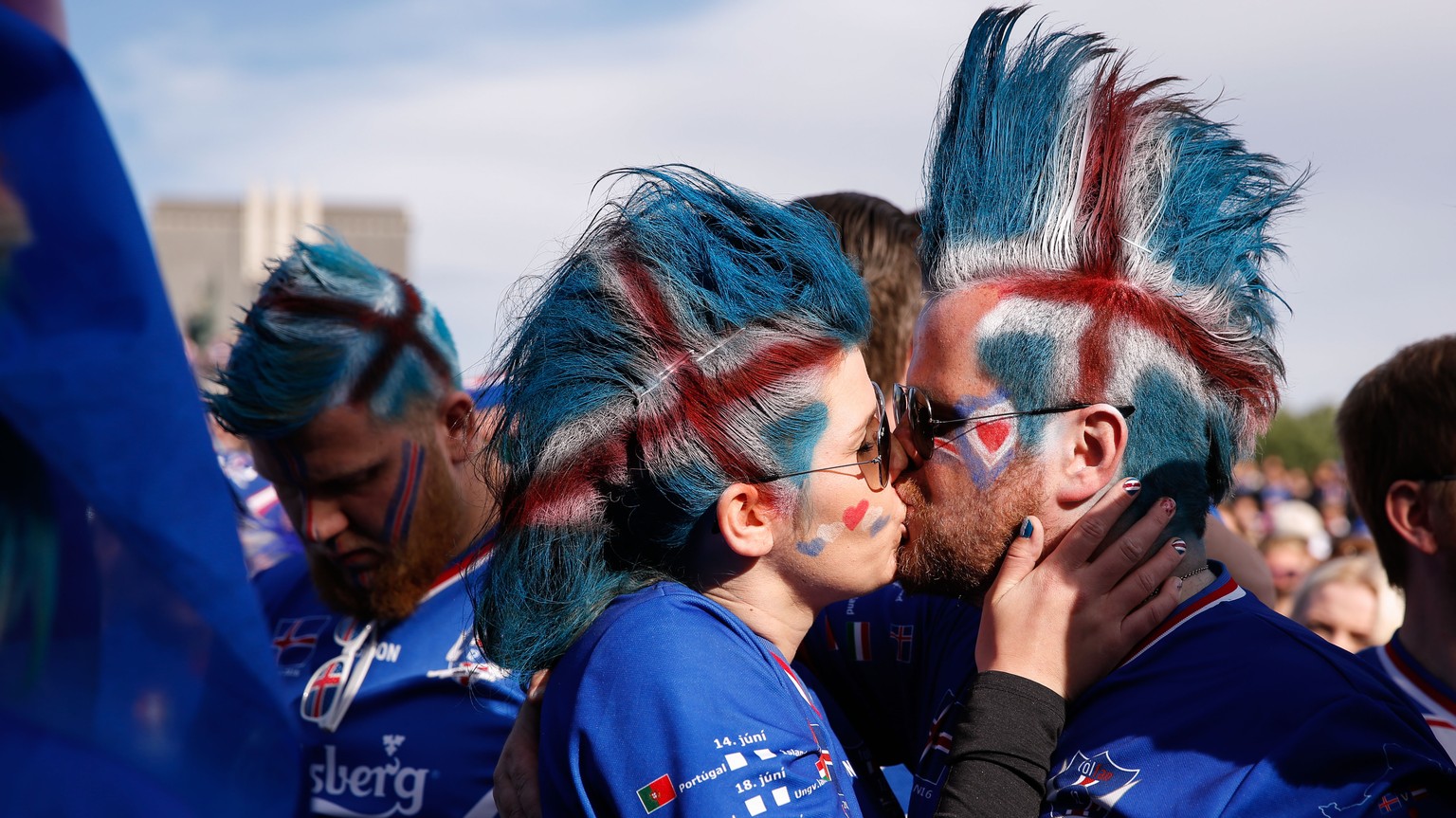 Iceland soccer fans kiss prior to watching the Euro 2016 quarterfinal match between Iceland and France on a large screen in Reykjavik, Iceland, Sunday July 3, 2016. (AP Photo/Brynjar Gunnarsson)