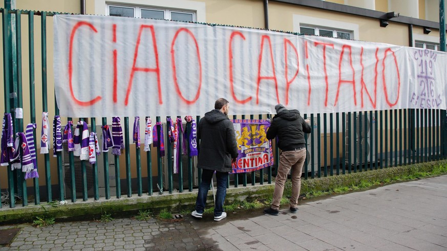 epa06579378 ACF Fiorentina supporter put up scarves, flowers and banners in memory of Fiorentina&#039;s deceased captain Davide Astori outside the Artemio Franchi stadium in Florenze, Italy, 04 March  ...