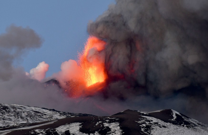 epa09016862 A spectacular eruption is underway on Etna volcano with a strong explosive activity from the south-east crater and the emission of a high cloud of lava ash that disperses towards the south ...
