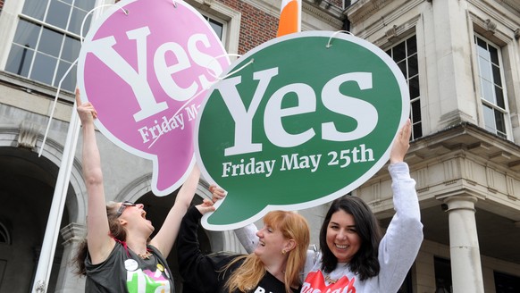 epa06764672 Women celebrate with Yes vote signs after a referndum on abortion, in Dublin, Ireland, 26 May 2018. Ireland has voted overwhelmingly to legalize abortion in a historic referendum on 25 May ...