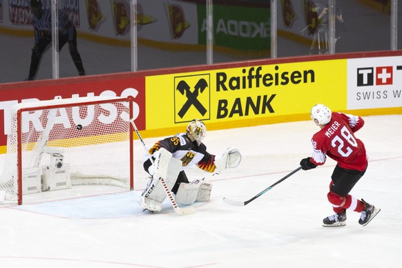 Switzerland&#039;s forward Timo Meier, right, scores a goal against Germany&#039;s goaltender Mathias Niederberger, left, during the shootout session, at the IIHF 2021 World Championship quarter final ...