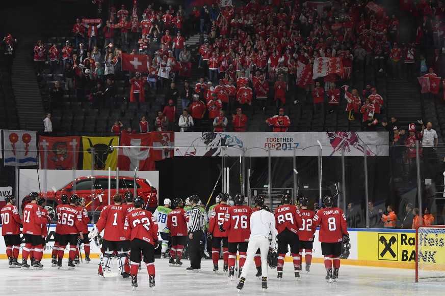 Switzerland’s players celebrate with their supporters after their Ice Hockey World Championship group B preliminary round match between Switzerland and Slovenia in Paris, France on Saturday, May 6, 20 ...