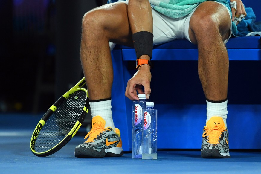 epa07308880 Rafael Nadal of Spain arranges his water bottles during a break in his men&#039;s singles quarter final match against Frances Tiafoe of the USA at the Australian Open Grand Slam tennis tou ...