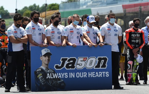 epa09236737 MotoGP riders and teams line up for one minute of silence in memory of Swiss Moto3 rider Jason Dupasquier, who died in an accident during qualifying, during the Motorcycling Grand Prix of  ...