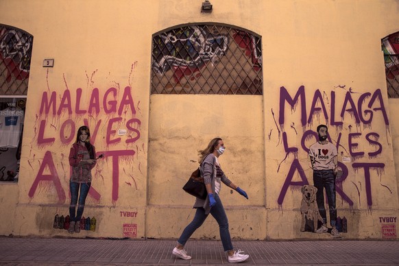 epa08393877 A woman walks in central Malaga, Spain, 30 April 2020 amid the ongoing coronavirus COVID-19 pandemic. Spain is in the seventh week of lockdown ordered by the government in an attempt to fi ...