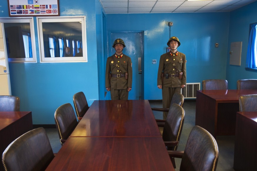 FILE - In this April 17, 2011, file photo, North Korean soldiers stand guard inside the building shared by North and South Korea at the truce village of Panmunjom at the Demilitarized Zone (DMZ) which ...