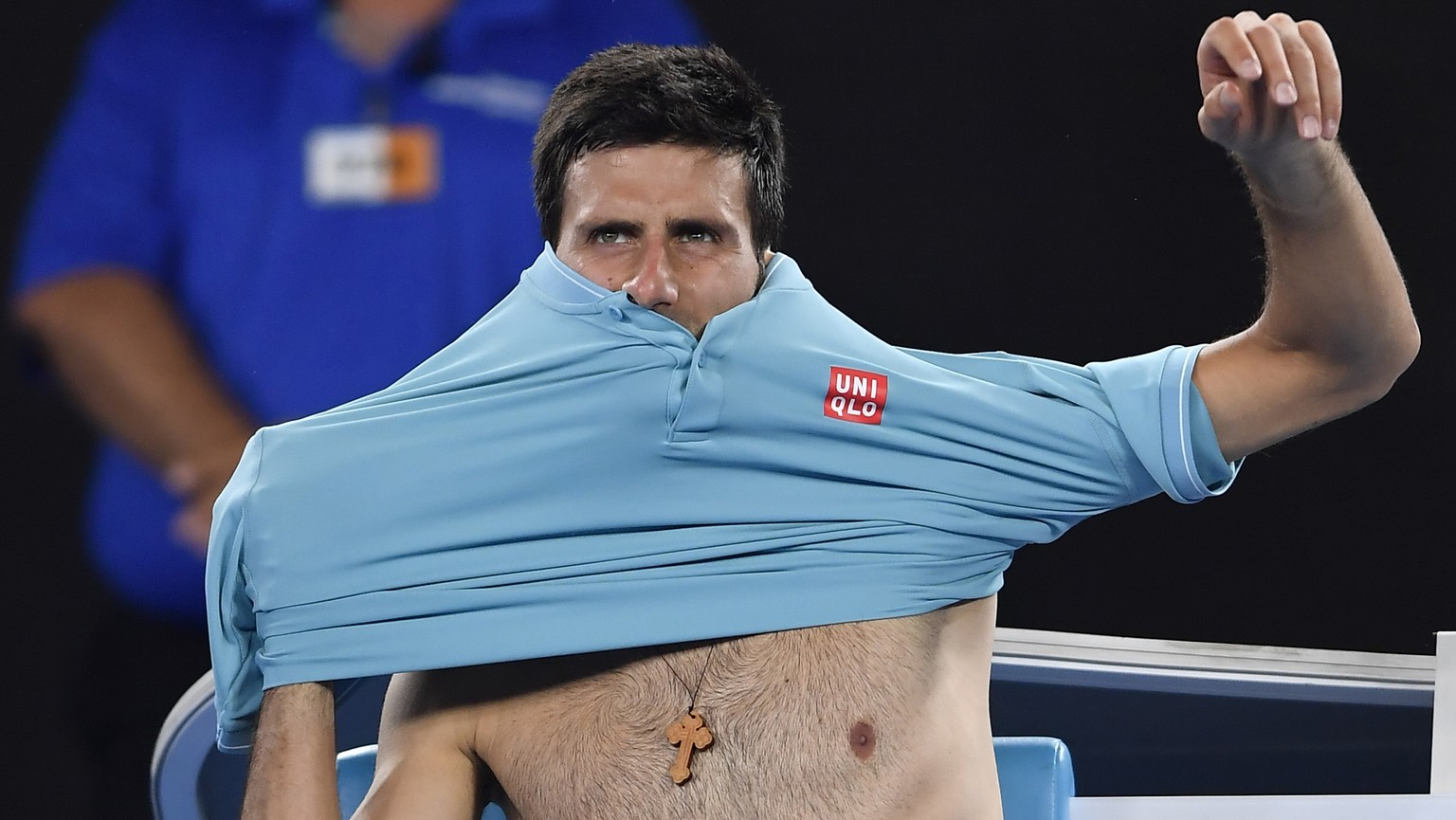 Serbia&#039;s Novak Djokovic changes his shirt between playing against Spain&#039;s Fernando Verdasco during their first round match at the Australian Open tennis championships in Melbourne, Australia ...