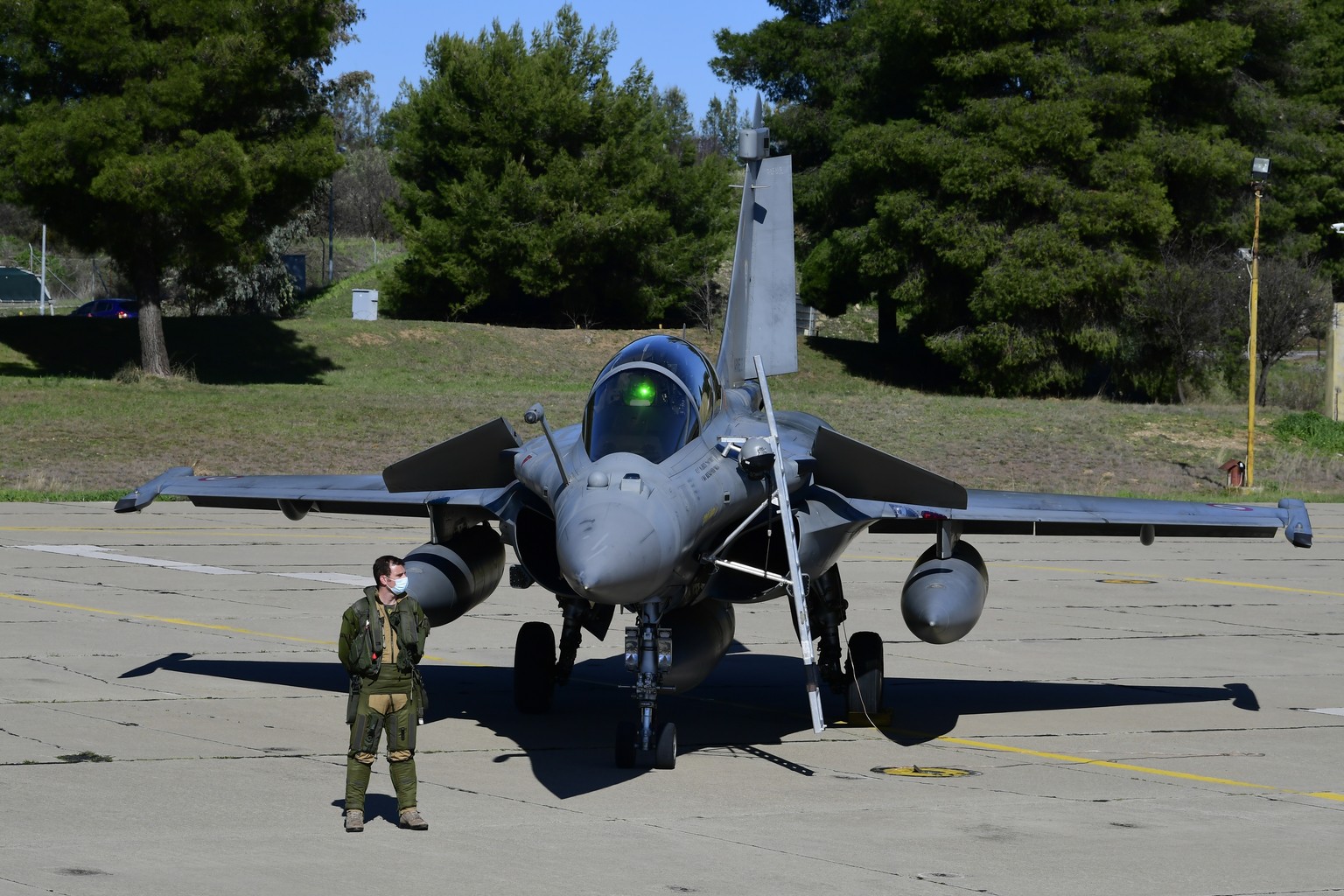 A Hellenic Airforce pilot stands by a French Airforce Rafale fighter jet during a joint military drill, at Tanagra military air base, about 82 kilometres (51miles) north of Athens, Greece, Thursday, F ...