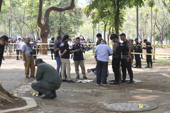 Police investigators inspect the site of an explosion in Jakarta, Indonesia, Tuesday, Dec. 3, 2019. An explosion from a smoke grenade occurred Tuesday near the presidential palace in Indonesia&#039;s  ...