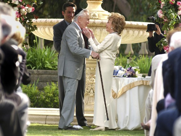 Zum Tod von Kirk Douglas: Actor Kirk Douglas and his wife, Anne, embrace after reaffirming their wedding vows Sunday, May 23, 2004, in Beverly Hills, Calif. The Douglas couple celebrated 50 years of m ...