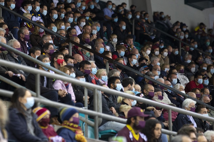 Spectators wearing protective face masks against the spread of the coronavirus COVID-19 watch the game, during a National League regular season game of the Swiss Championship between Geneve-Servette H ...