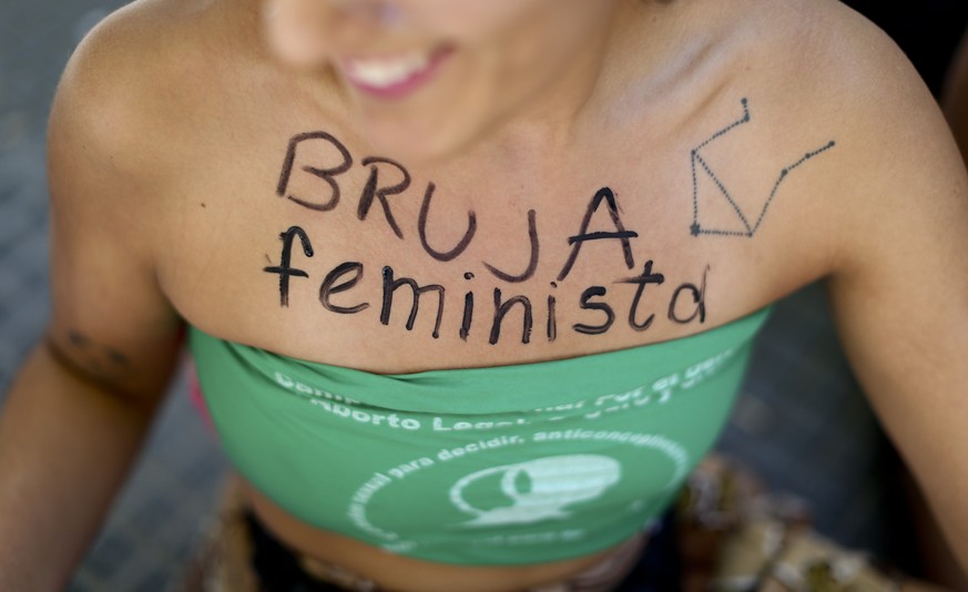 A woman dons the Spanish words for &quot;feminist witch&quot; on her chest during a demonstration celebrating International Women&#039;s Day, in Buenos Aires, Argentina, Thursday, March 8, 2018. Tens  ...