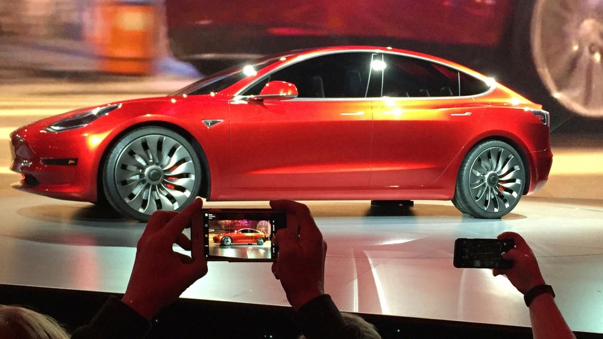 FILE- In this March 31, 2016, file photo, Tesla Motors unveils the new lower-priced Model 3 sedan at the Tesla Motors design studio in Hawthorne, Calif. Electric car maker Tesla Inc. increased product ...