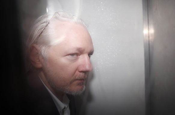 WikiLeaks founder Julian Assange is seen in a prison van traveling to Westminster Magistrates Court in London, Friday, Dec. 20, 2019. Assange is expected to appear in person before Westminster Magistr ...