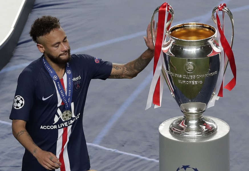 PSG&#039;s Neymar touches the trophy after the Champions League final soccer match between Paris Saint-Germain and Bayern Munich at the Luz stadium in Lisbon, Portugal, Sunday, Aug. 23, 2020. (AP Phot ...