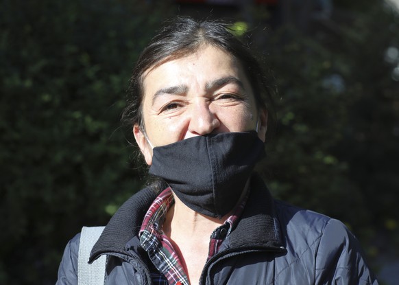 FILE - In this May 24, 2020 file photo, Muyesser Yildiz wears a face mask to protect against the coronavirus as she visits a public garden, in Ankara, Turkey. Turkish police on Monday June 8, 2020, de ...
