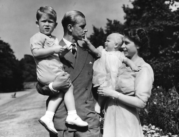 FILE - In this Aug. 1951 file photo then Princess Elizabeth stands with her husband Prince Philip, the Duke of Edinburgh, and their children Prince Charles and Princess Anne at the couple&#039;s Londo ...