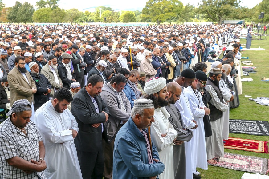 epa07454802 People attend a prayer at Hagley Park, opposite the Al Noor Mosque in Christchurch, New Zealand, 22 March 2019. New Zealand Prime Minister Jacinda Ardern announced on 21 March, that New Ze ...