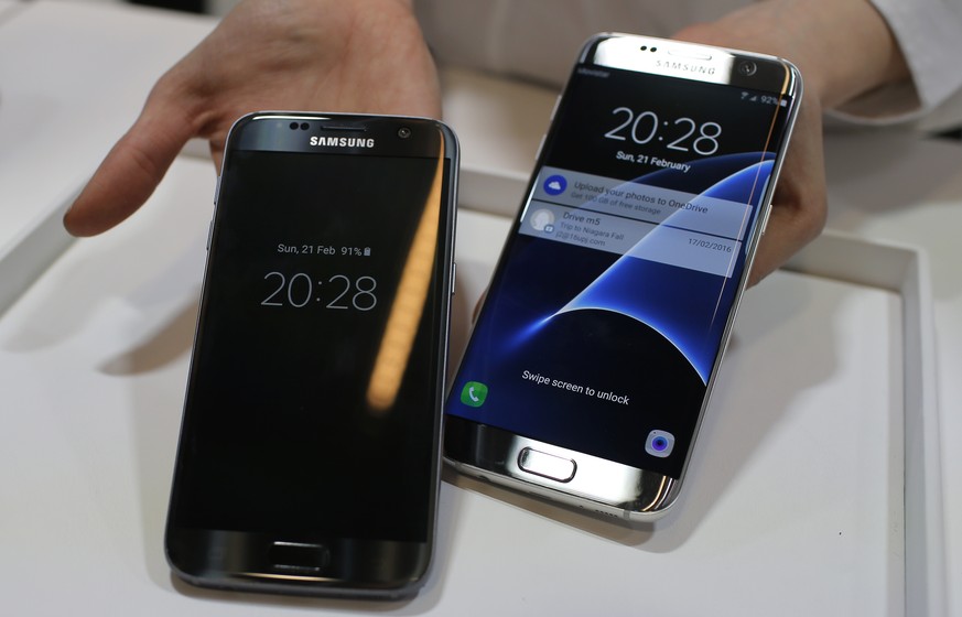 FILE - In this Sunday, Feb. 21, 2016, file photo, a Samsung Galaxy S7, left, and S7 Edge are displayed during the Samsung Galaxy Unpacked 2016 event on the eve of the Mobile World Congress wireless sh ...