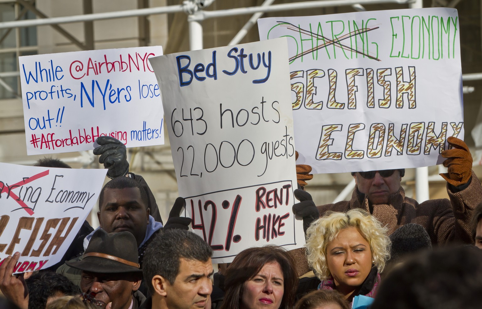 Opponents of Airbnb hold a rally outside City Hall, Tuesday, Jan. 20, 2015, in New York. With home-as-hotel sites like Airbnb doing booming business, New York City lawmakers are holding a hearing to s ...