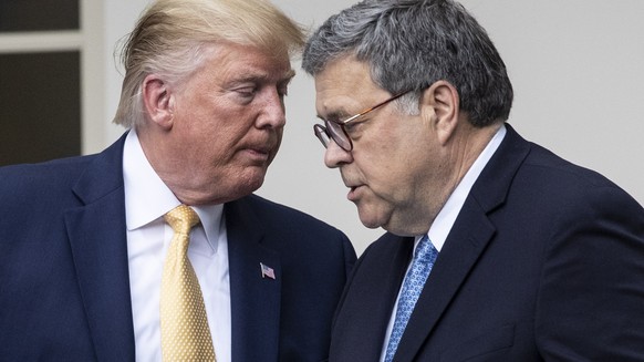epa07873332 (FILE) - US President Donald J. Trump (L) hands over the podium to US Attorney General William Barr (R) while participating in an announcement on US citizenship and the census, in the Rose ...