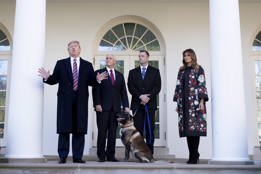 epa08025031 US President Donald J. Trump (L) delivers remarks beside US Vice President Mike Pence (2-L), US Army dog Conan (C) and First Lady Melania Trump (R), in the Rose Garden of the White House i ...