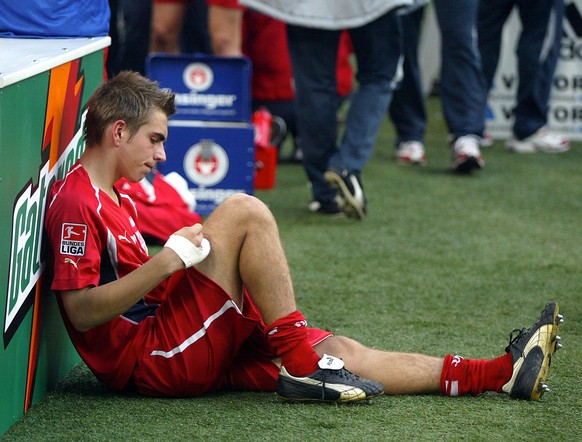 Philipp Lahm from Stuttgart sits near the pitch after losing the German first division soccer match between FC Schalke 04 and VFB Stuttgart at the Arena AufSchalke in Gelsenkirchen, Germany, Saturday, ...