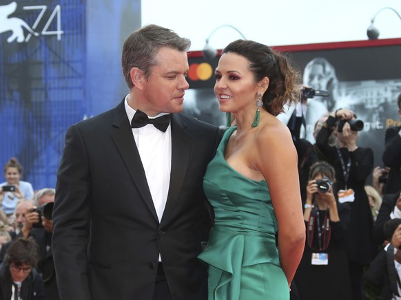 Actor Matt Damon, left, and his wife Luciana Barroso pose for photographers upon arrival at the premiere of the film &#039;Suburbicon&#039; during the 74th edition of the Venice Film Festival in Venic ...