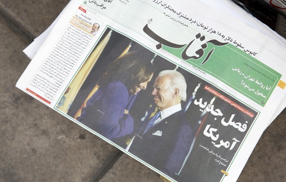 epa08807225 A copy of Iranian daily newspaper Aftab with a picture of US president elect Joe Biden and his Vice President Kamala Harris and head line &#039;New chapter of US&#039; is displayed in fron ...