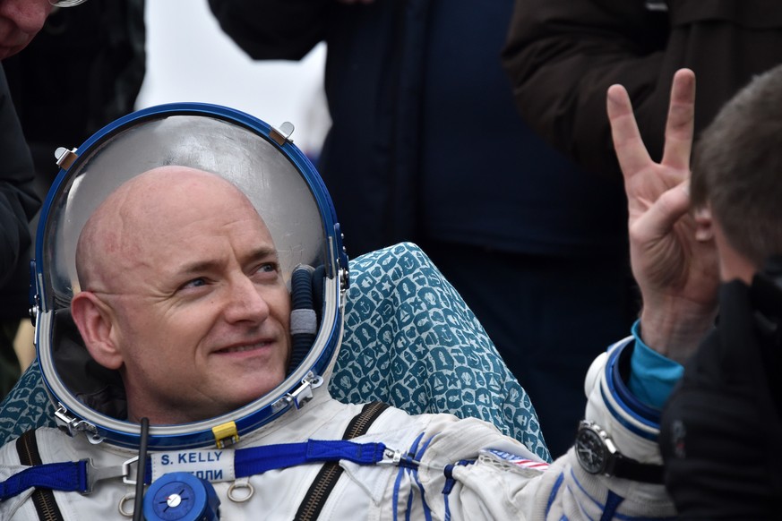International Space Station (ISS) crew member Scott Kelly of the U.S. shows a victory sign after landing near the town of Dzhezkazgan, Kazakhstan, on Wednesday, March 2, 2016. The Soyuz TMA-18M spacec ...