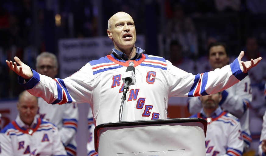 Mark Messier gestures to fans while speaking during a ceremony to acknowledge the 25th anniversary of the 1994 New York Rangers winning the Stanley Cup, before an NHL hockey game between the Rangers a ...