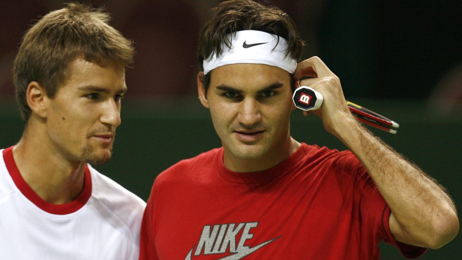World number one tennis player Roger Federer of Switzerland, right, and teammate Marco Chiudinelli, left, speak together during the first training session before their Davis Cup World Group Play-offs  ...