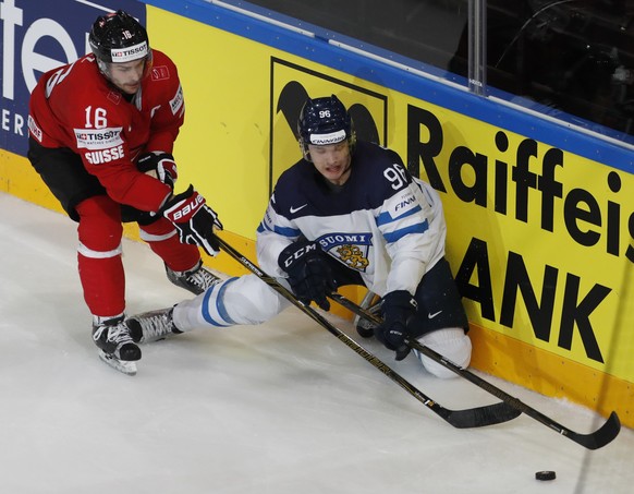 Switzerland&#039;s Raphael Diaz, left, challenges Finland&#039;s Mikkao Rantanen, right, during the Ice Hockey World Championships group B match between Switzerland and Finland in the AccorHotels Aren ...