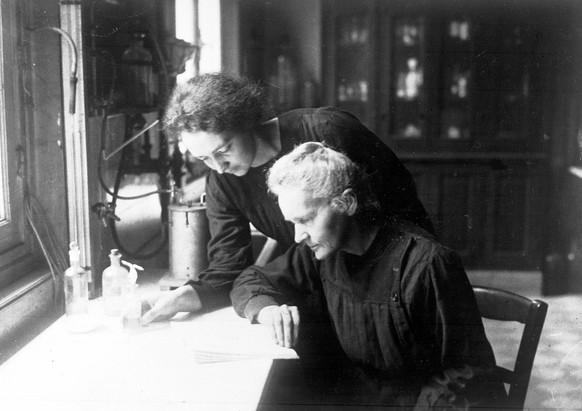 Polish-French physicist and chemist Madame Marie Curie, seated front, works in a laboratory, with her daughter Irene, in Paris France, April 20, 1927. Curie, along with her husband, Pierre, first isol ...