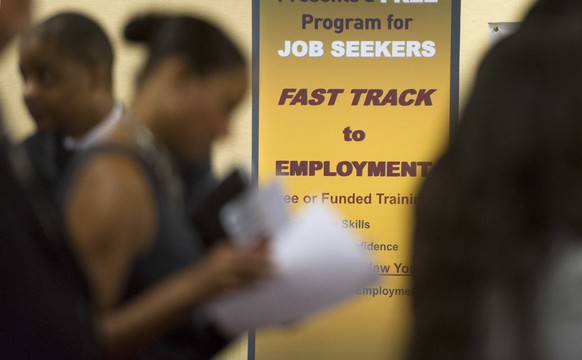 FILE - In this May 30, 2013, file photo, job seekers line up to talk to recruiters during a job fair held in Atlanta. On Friday, Sept. 15, 2017, the Labor Department reports on state unemployment rate ...