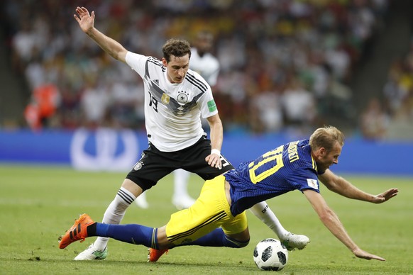 Sweden&#039;s Ola Toivonen falls in front of Germany&#039;s Sebastian Rudy during the group F match between Germany and Sweden at the 2018 soccer World Cup in the Fisht Stadium in Sochi, Russia, Satur ...