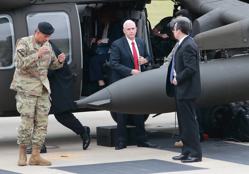 epa05911813 US Vice President Mike Pence (C) disembarks from a helicopter at a US military base near the inter-Korean border in Paju, South Korea, 17 April 2017, before a visit to the truce village of ...