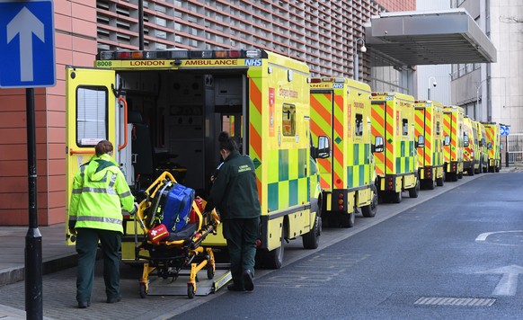 epa08916913 Ambulance workers outside the Royal London Hospital in London, Britain, 03 January 2021. Coronavirus cases are continuing to surge across England with hospital admissions reaching new high ...