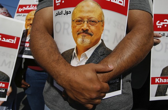 People hold posters of slain Saudi journalist Jamal Khashoggi, near the Saudi Arabia consulate in Istanbul, marking the two-year anniversary of his death, Friday, Oct. 2, 2020. The gathering was held  ...