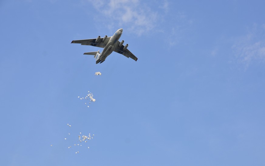 In this photo taken Tuesday, Dec. 5, 2017, a World Food Program plane drops food aid over the town of Jiech, Ayod County, South Sudan. As South Sudan enters its fifth year of civil war, 1.25 million p ...
