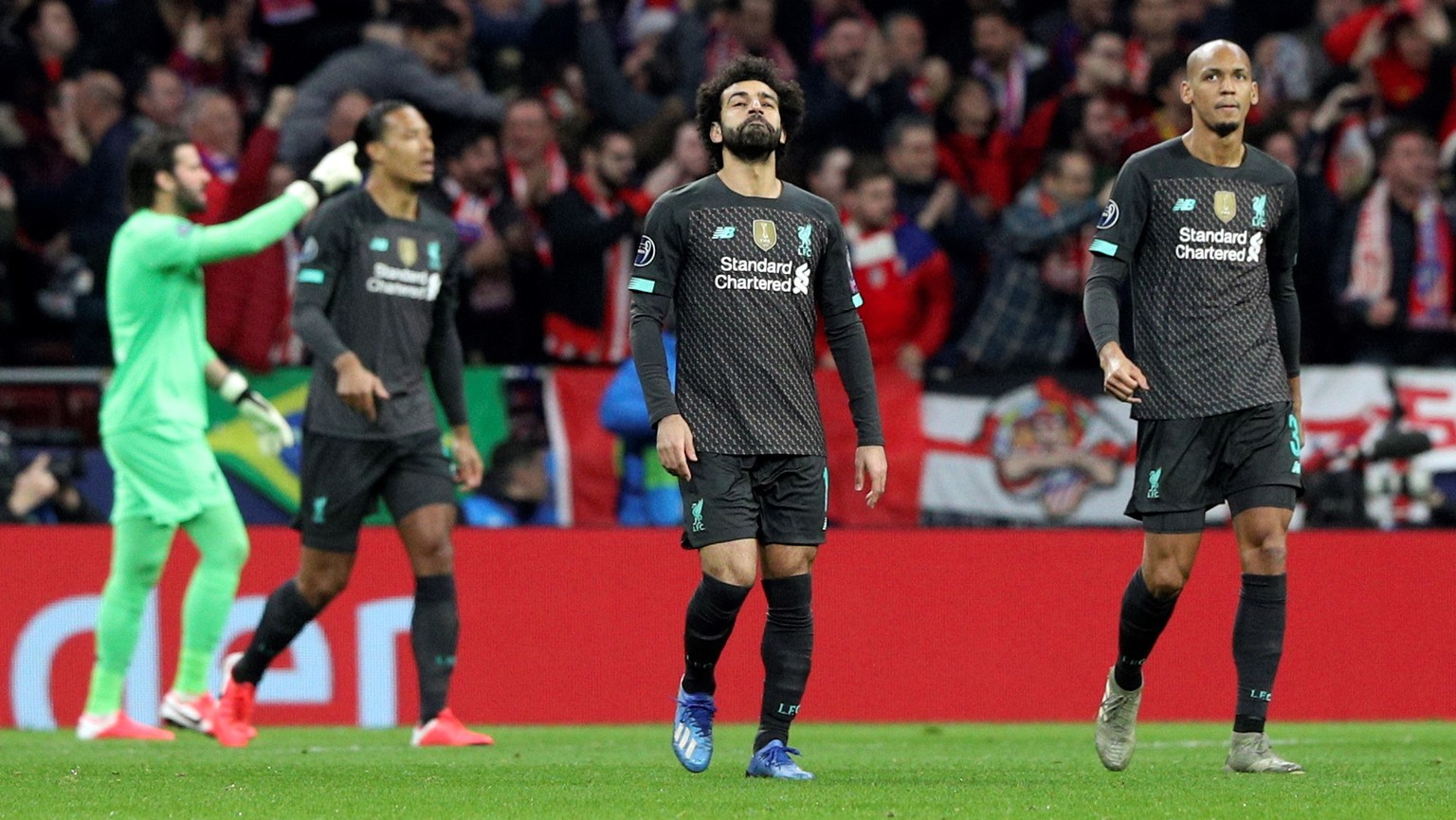 epa08226566 Liverpool&#039;s winger Mohamed Salah (C) and midfielder Fabinho (R) react after the conceding 1-0 goal during the UEFA Champions League round of 16 first leg match between Atletico de Mad ...