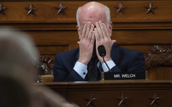 Rep. Peter Welch, D-Vt., covers his face while attending the House Intelligence Committee hearing on Capitol Hill in Washington, Wednesday, Nov. 13, 2019, during the first public impeachment hearing o ...