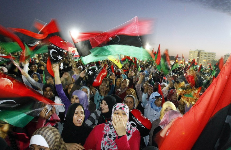 File - In this Sunday Oct. 23, 2011 file photo, Libyan celebrate at Saha Kish Square in Benghazi, Libya, as Libya&#039;s transitional government declares the official liberation of Libya after months  ...