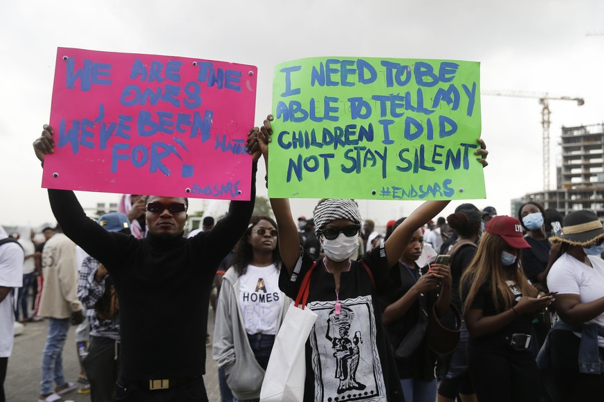 People hold banners as they demonstrate on the street to protest against police brutality in Lagos, Nigeria, Tuesday Oct. 13, 2020. Crowds protesting against police brutality in Nigeria have taken to  ...